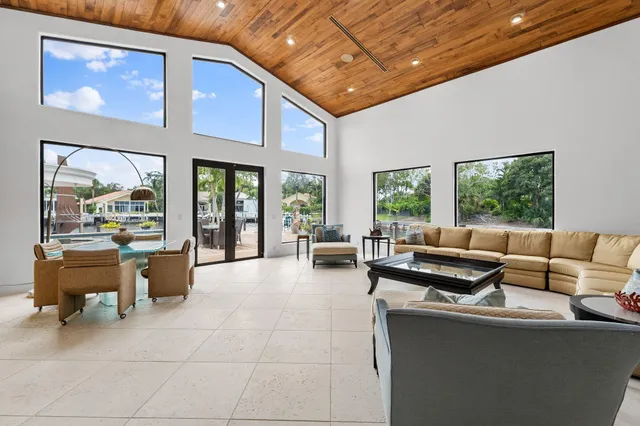 a view of a balcony with dining table & chairs with wooden floor