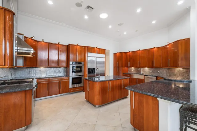 an aerial view of a house with a garden and lake view