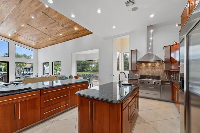 an aerial view of lake and residential houses with outdoor space