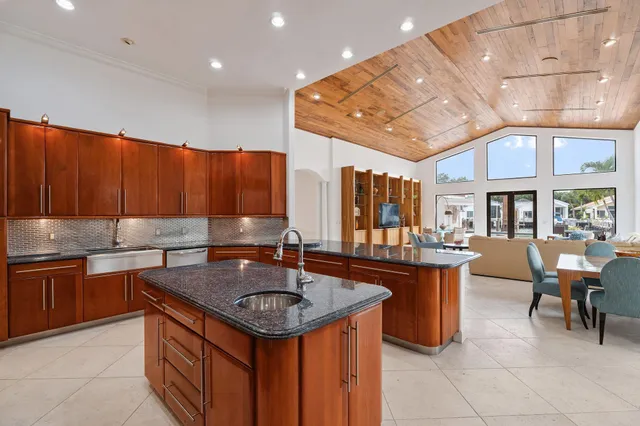 an aerial view of lake and residential houses with outdoor space