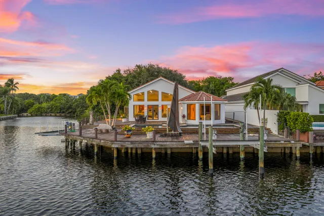 a kitchen with granite countertop stainless steel appliances a sink stove and cabinets