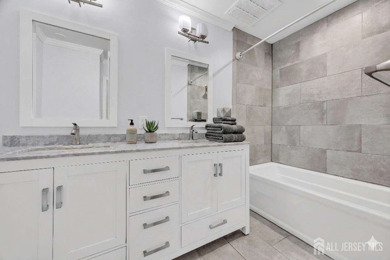 9 Carriage Place Edison, NJ 08820 - Photo 11 of 21 a bathroom with a granite countertop sink a mirror and a bathtub