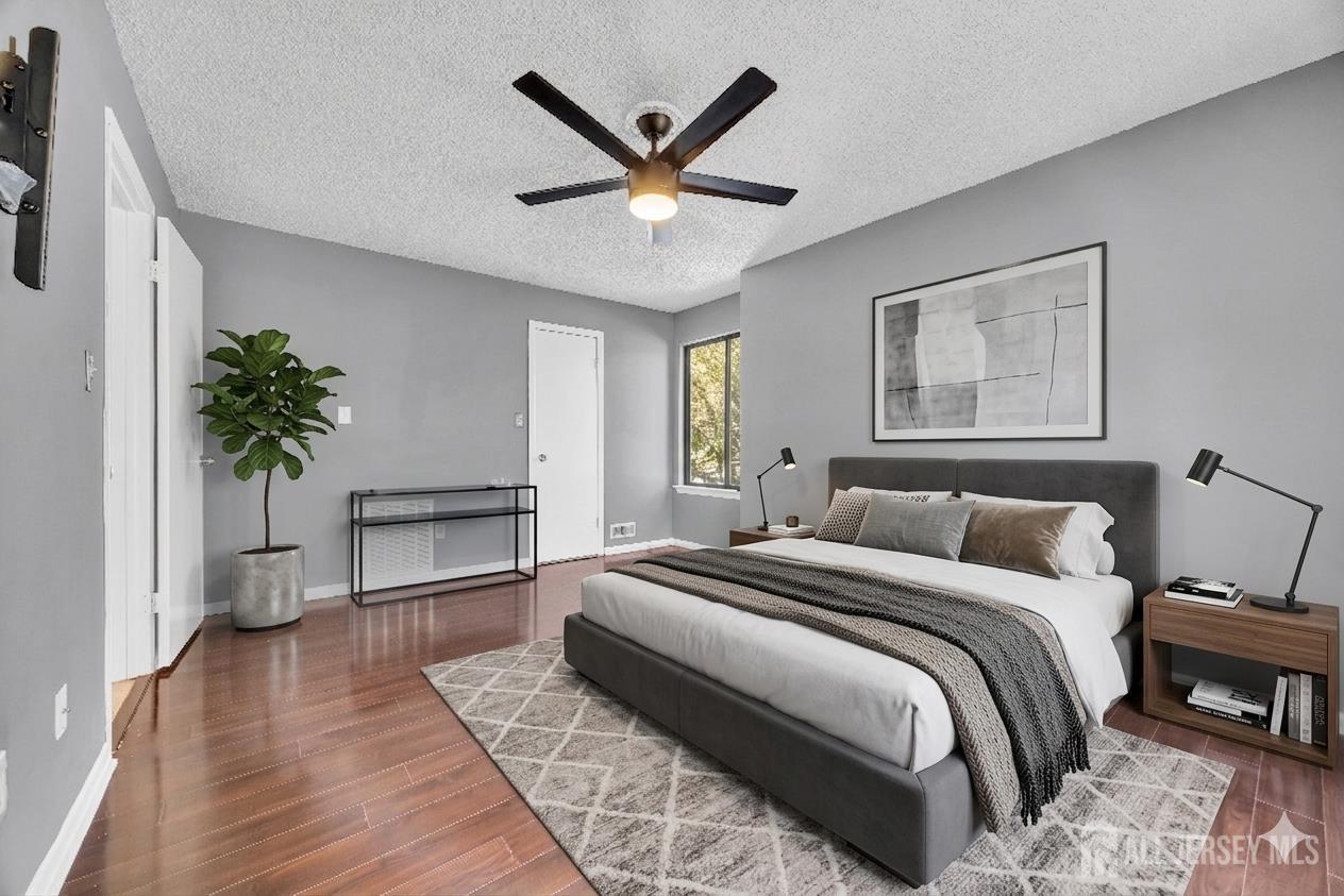 9 Carriage Place Edison, NJ 08820 - Photo 15 of 21 a bedroom with a large bed a chandelier and a potted plant