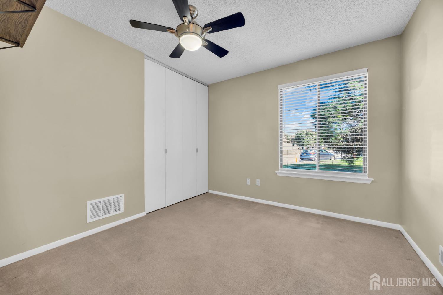 9 Carriage Place Edison, NJ 08820 - Photo 17 of 21 a view of a livingroom with a ceiling fan and window