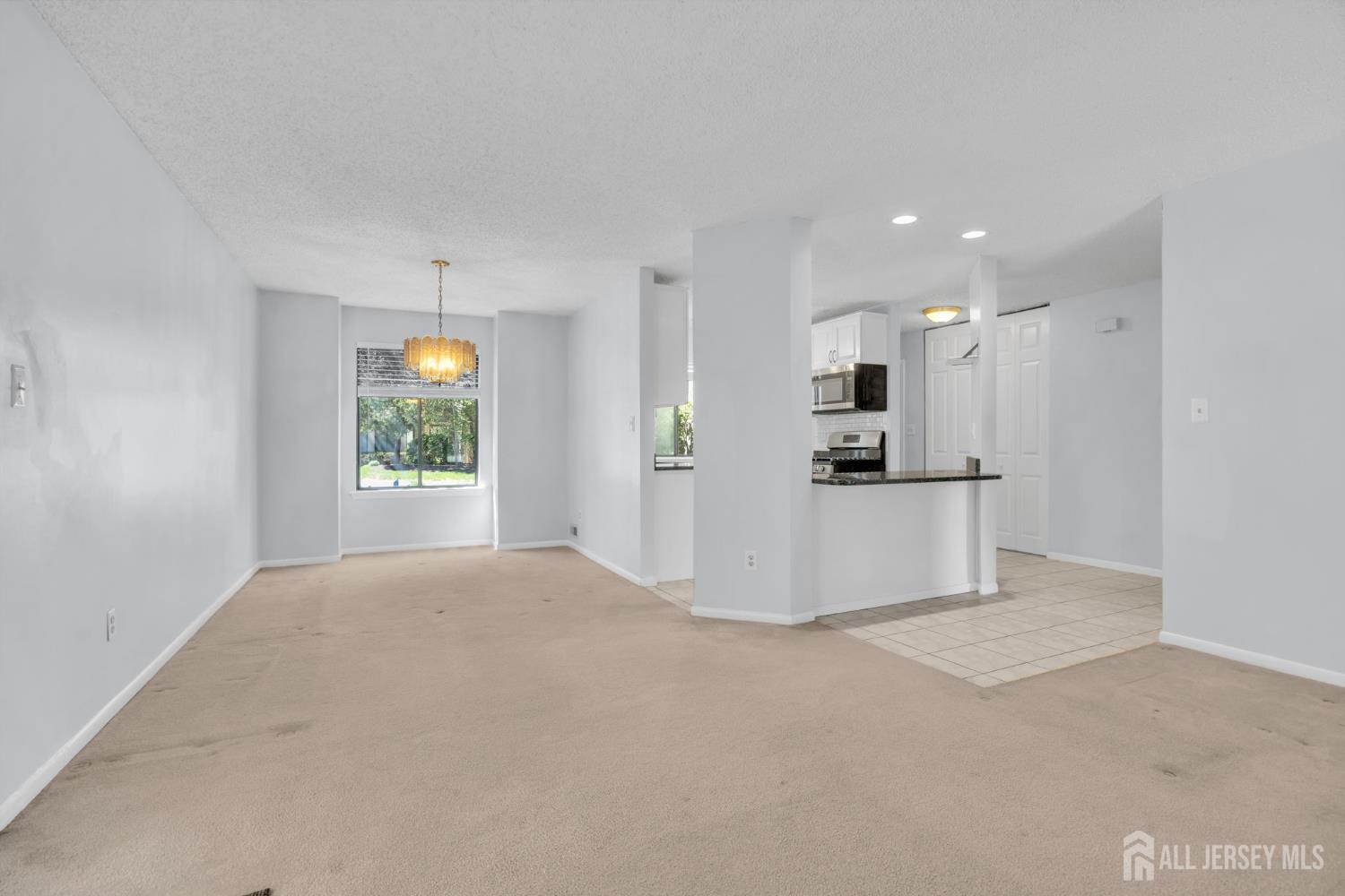 9 Carriage Place Edison, NJ 08820 - Photo 6 of 21 a view of a kitchen with a refrigerator wooden floor and a window