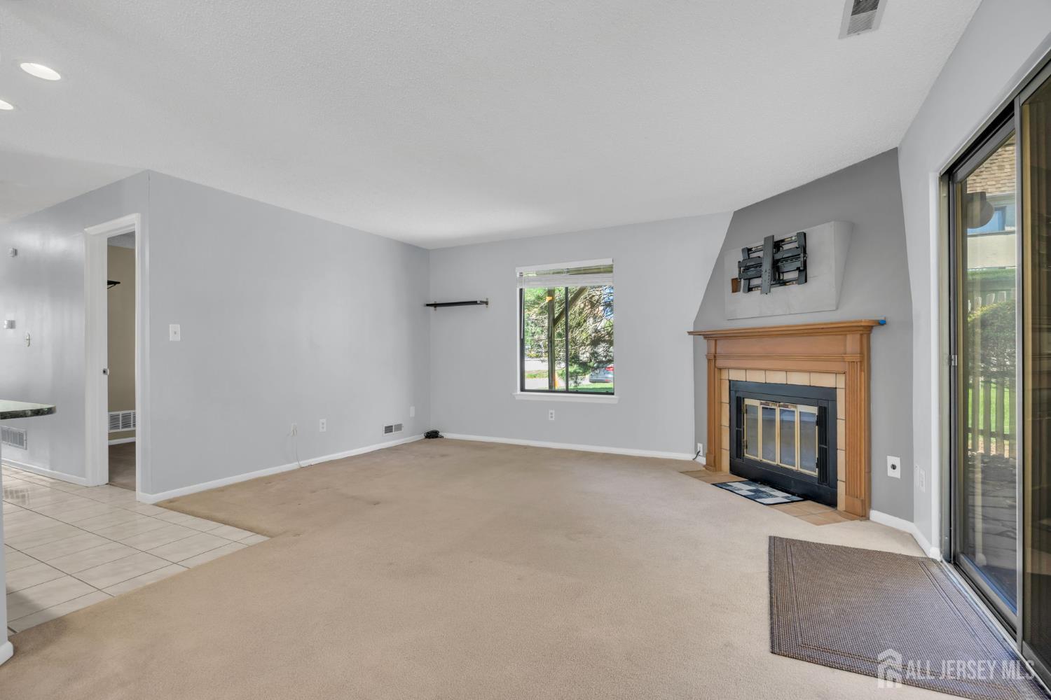 9 Carriage Place Edison, NJ 08820 - Photo 8 of 21 an empty room with a fireplace and windows