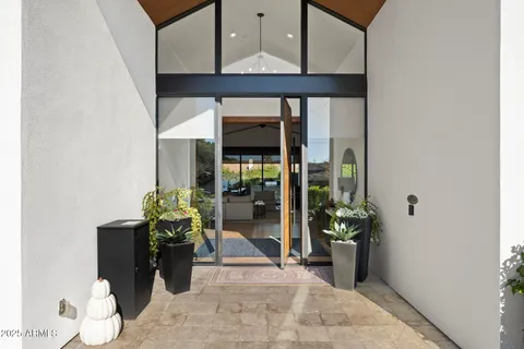 a large kitchen with stainless steel appliances kitchen island granite countertop a large island a stove a refrigerator a sink dishwasher a dining table and chairs with wooden floor