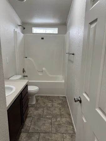 a view of an empty room with a bathroom