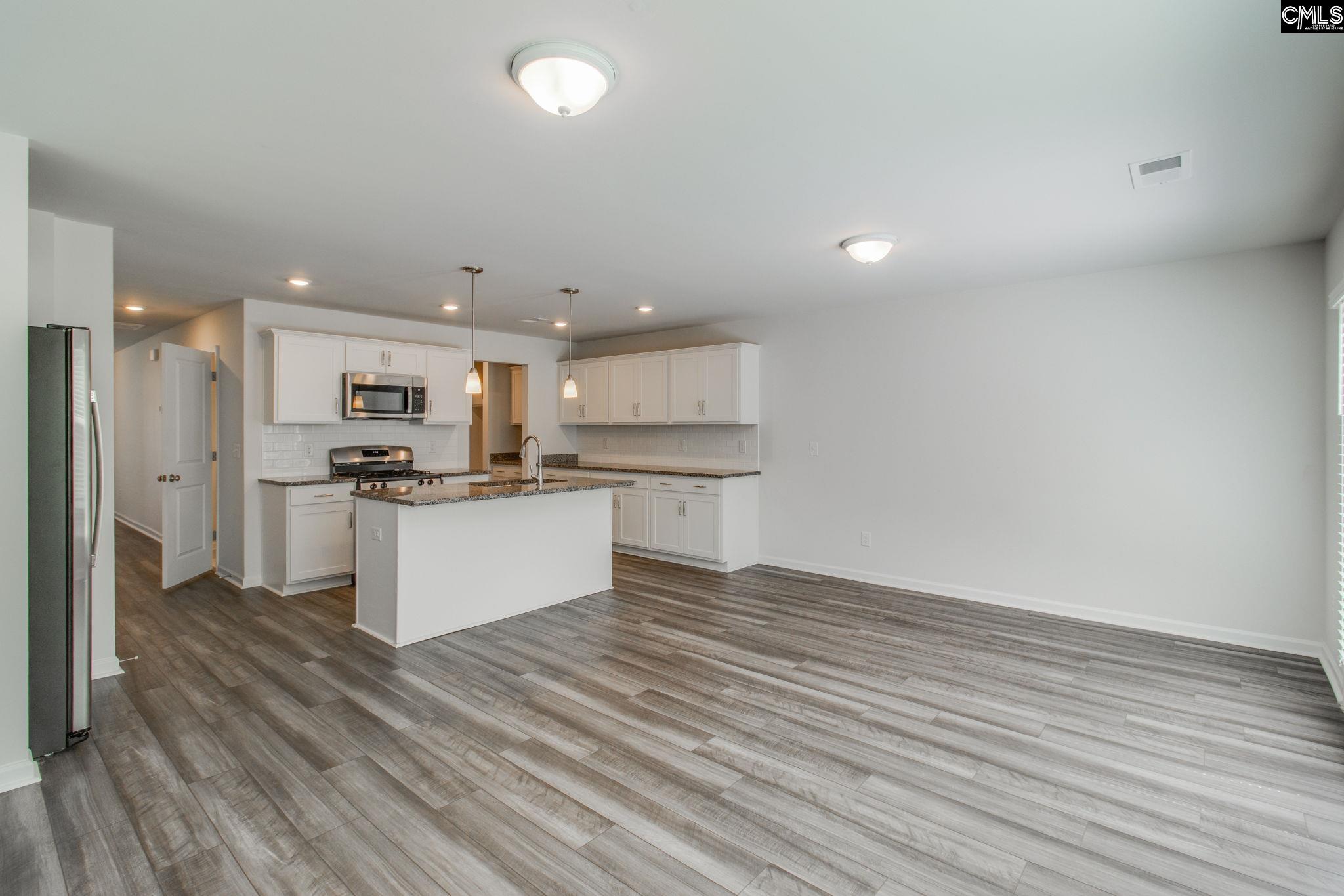 312 Reedmace Court Lexington, SC 29072 - Photo 9 of 29 a view of kitchen with granite countertop cabinets and refrigerator