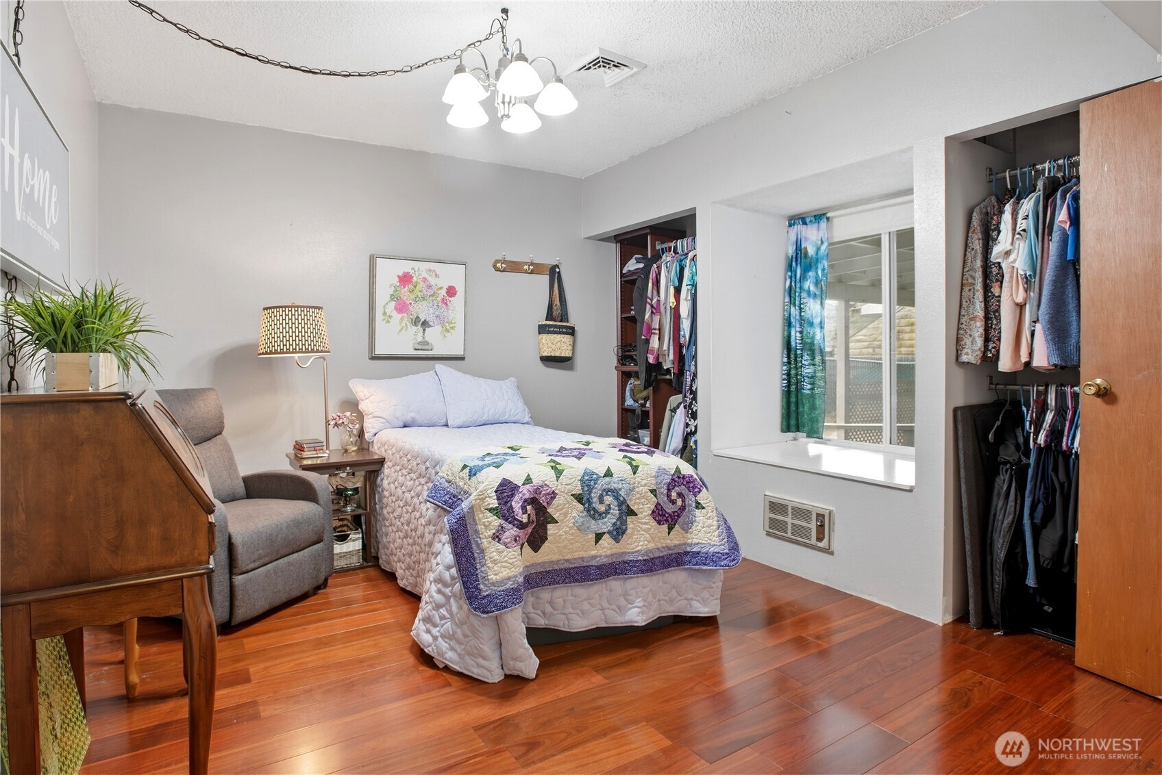 3506 Columbia Heights Road Longview, WA 98632 - Photo 14 of 22 a bedroom with a bed and a chandelier