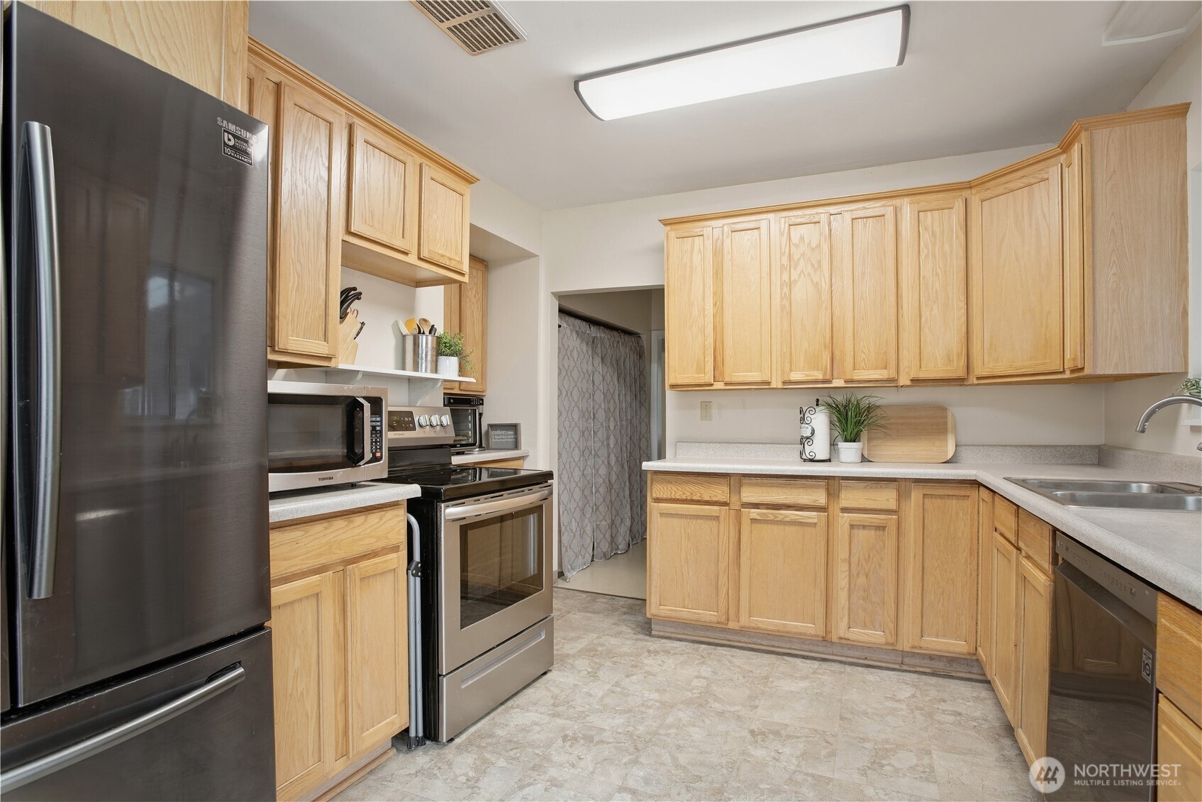 3506 Columbia Heights Road Longview, WA 98632 - Photo 9 of 22 a kitchen with a stove a sink and a refrigerator