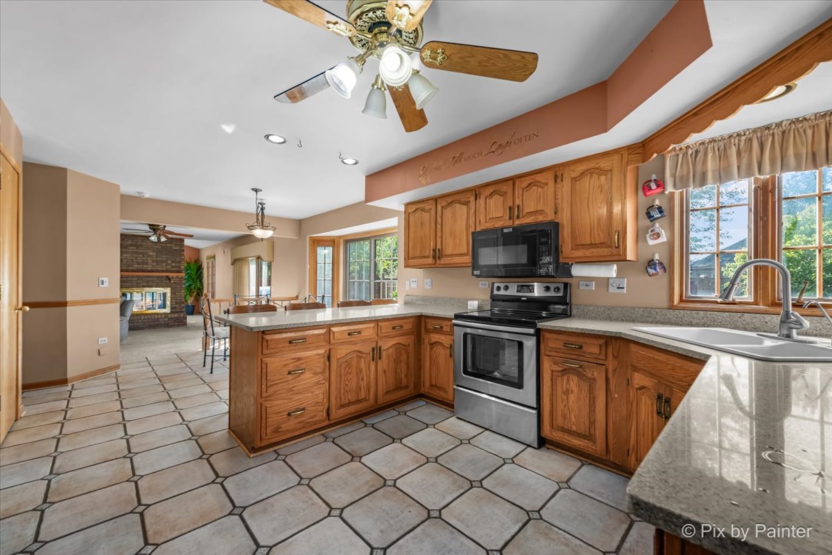 4319 Mc Cauley Road Woodstock, IL 60098 - Photo 12 of 52 a kitchen with stainless steel appliances granite countertop a stove and a sink