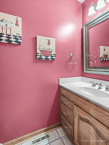 a bathroom with a granite countertop sink mirror vanity and toilet