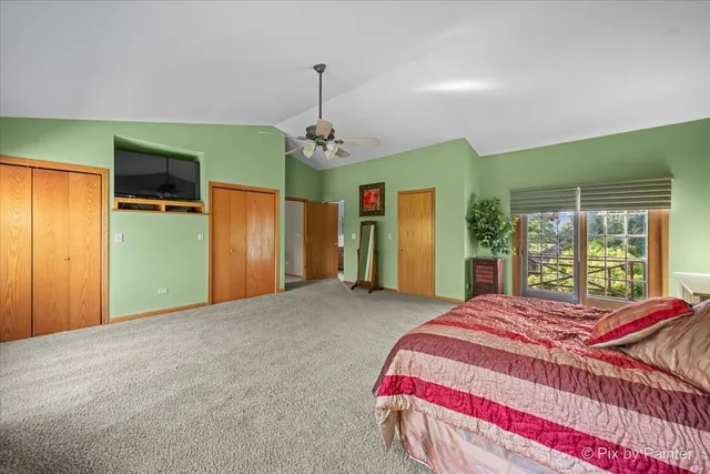 a bedroom with furniture and a large window