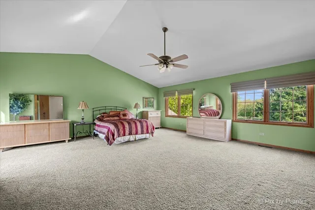 a bathroom with a granite countertop double vanity sink and a bathtub