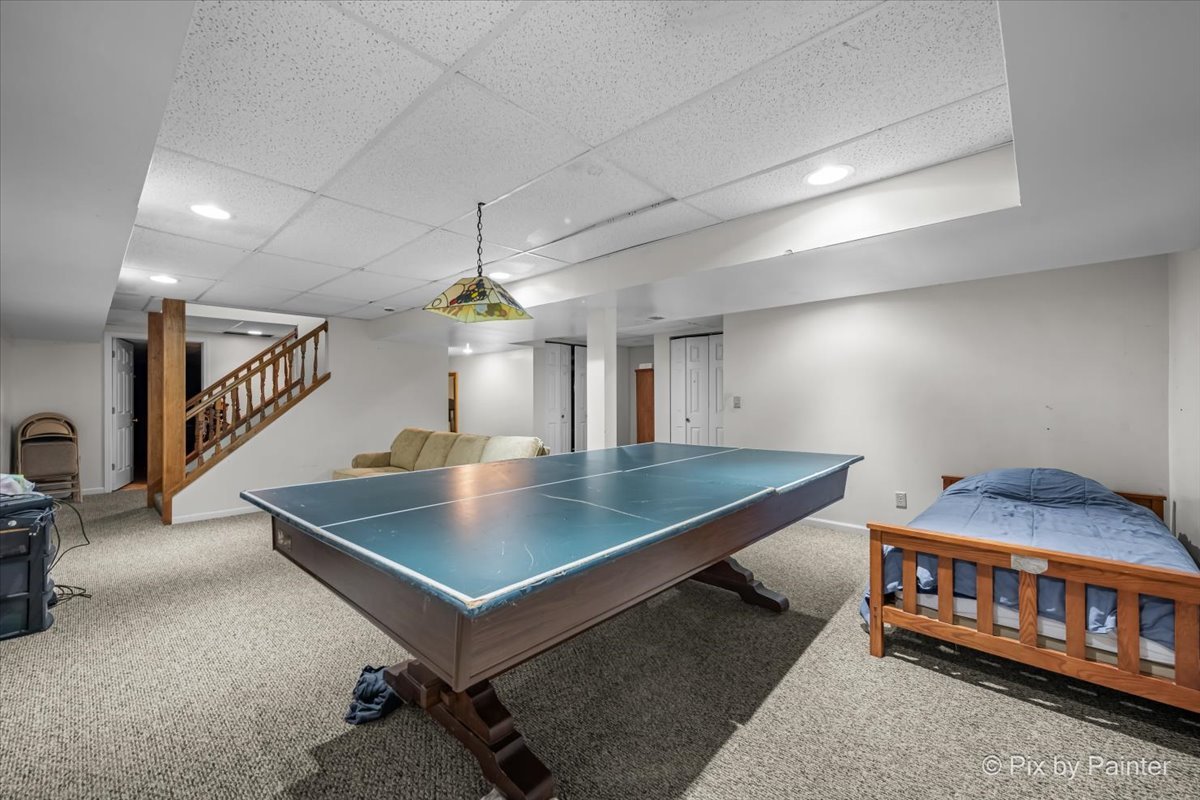 4319 Mc Cauley Road Woodstock, IL 60098 - Photo 29 of 52 a bedroom with furniture and a chandelier
