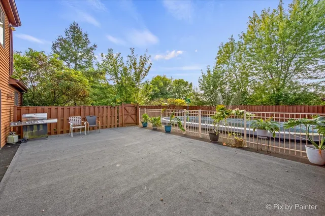 a backyard of a house with table and chairs