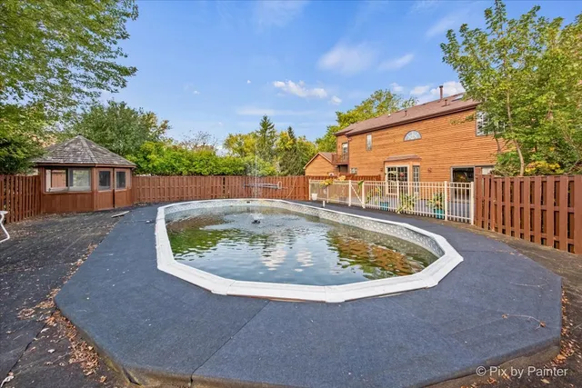 a small pool with trees in the background