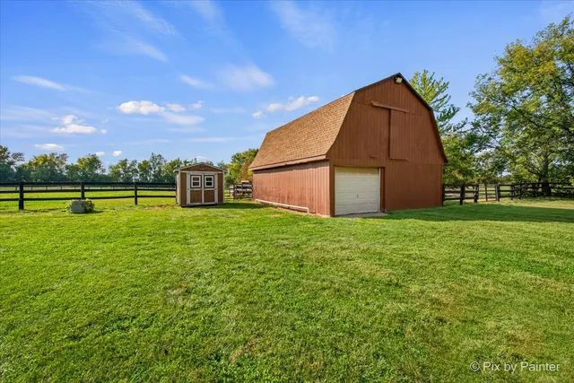 a view of backyard with table and chairs