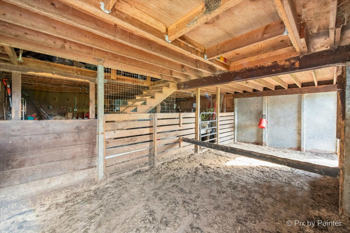 4319 Mc Cauley Road Woodstock, IL 60098 - Photo 39 of 52 a view of a garage with wooden wall and a window
