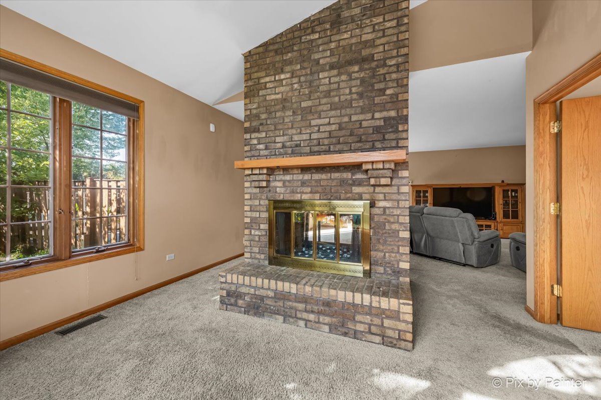 4319 Mc Cauley Road Woodstock, IL 60098 - Photo 7 of 52 a living room with furniture and a fireplace