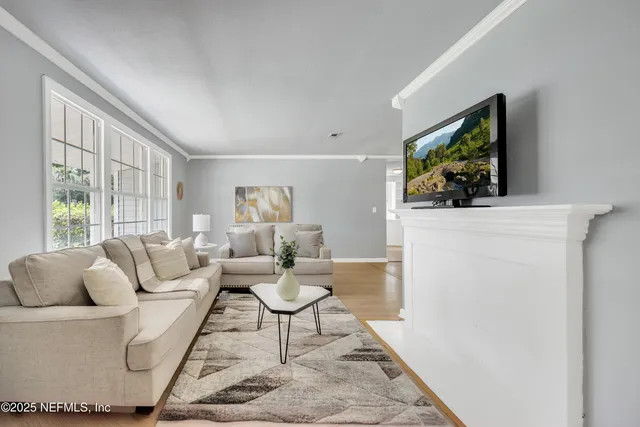 a living room with furniture and a flat screen tv