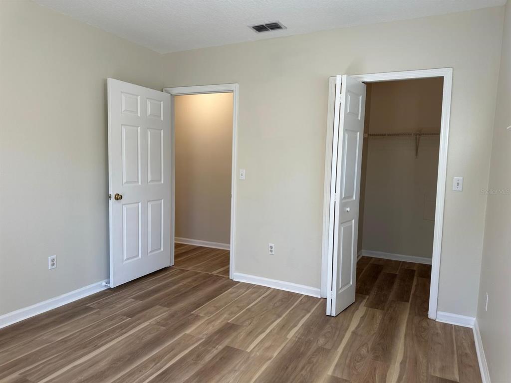 4308 South Kirkman Road, Unit 1 Orlando, FL 32811 - Photo 14 of 24 an empty room with wooden floor and closet