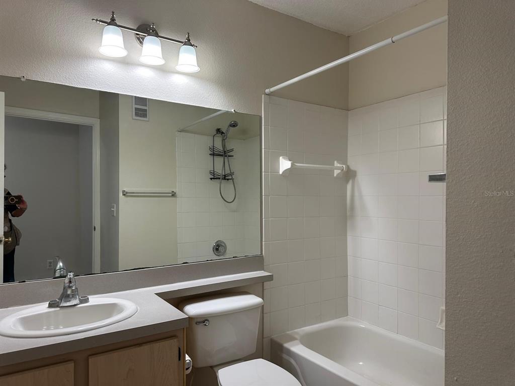 4308 South Kirkman Road, Unit 1 Orlando, FL 32811 - Photo 18 of 24 a bathroom with a sink a toilet and shower