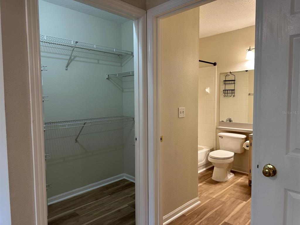 4308 South Kirkman Road, Unit 1 Orlando, FL 32811 - Photo 21 of 24 a bathroom with a granite countertop toilet a sink and shower