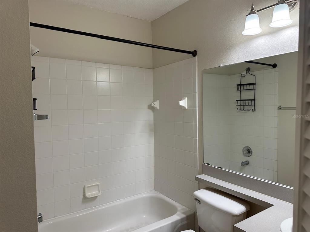 4308 South Kirkman Road, Unit 1 Orlando, FL 32811 - Photo 22 of 24 a bathroom with a shower and a toilet