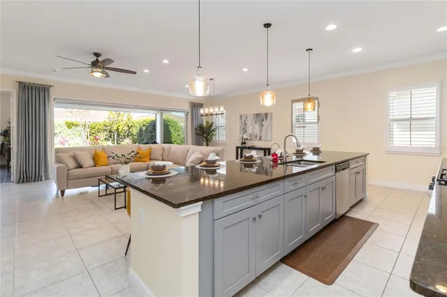 a kitchen with a sink and living room view