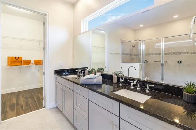 a bathroom with double sink and a mirror