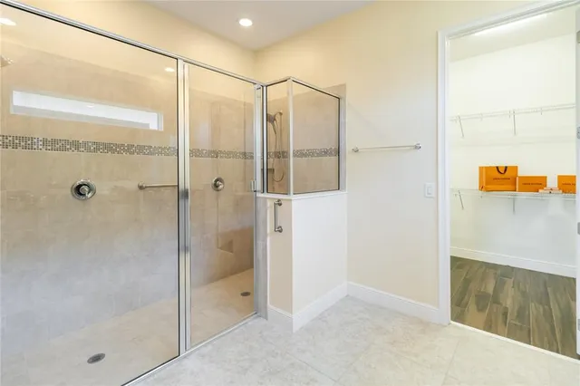 a bathroom with a shower and a glass door
