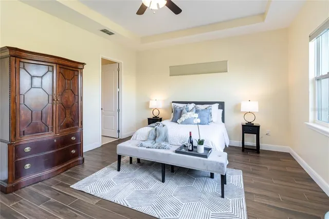 a bedroom with a bed and wooden floor