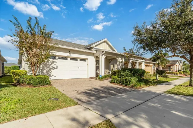 a front view of a house with a yard and a garage