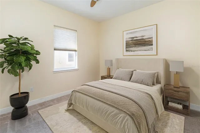 a bedroom with a bed and a potted plant