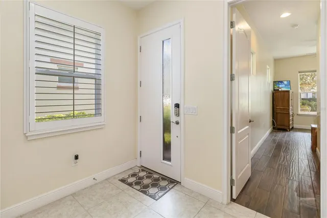 a view of a hallway with wooden floor and closet area