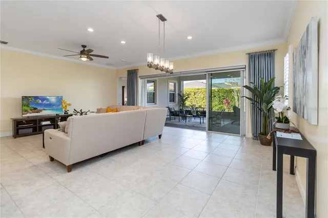 a living room with furniture and a chandelier