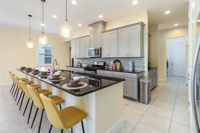 a kitchen that has a sink cabinets and wooden floor