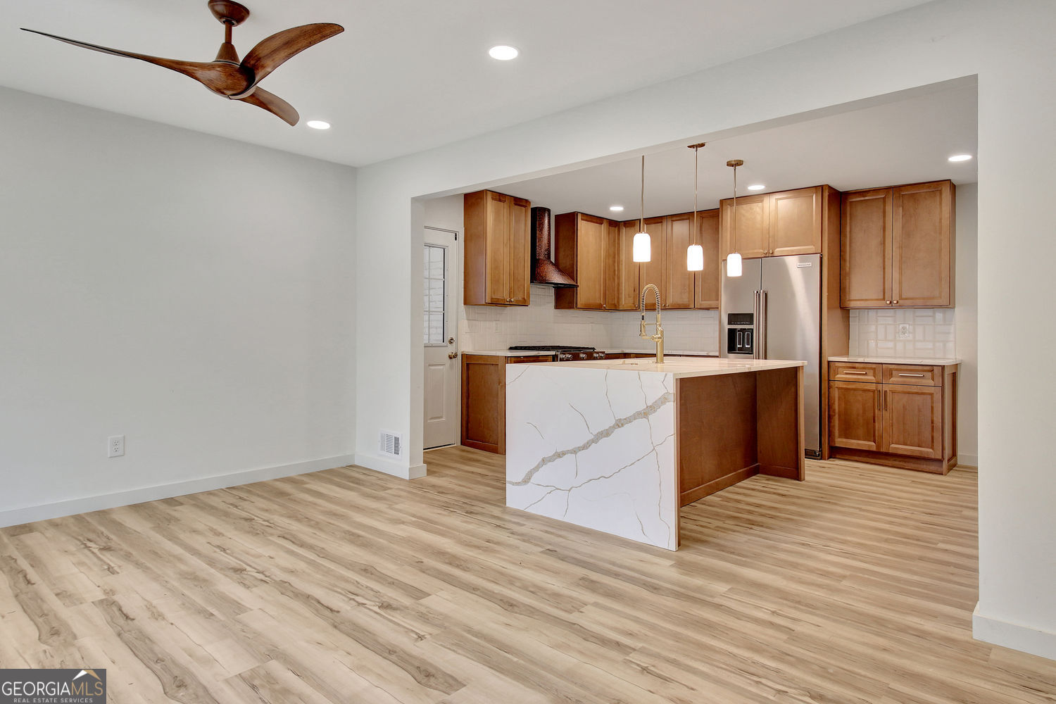 183 Pine Street Northeast Fairburn, GA 30213 - Photo 12 of 68 a large kitchen with stainless steel appliances granite countertop a stove and a sink