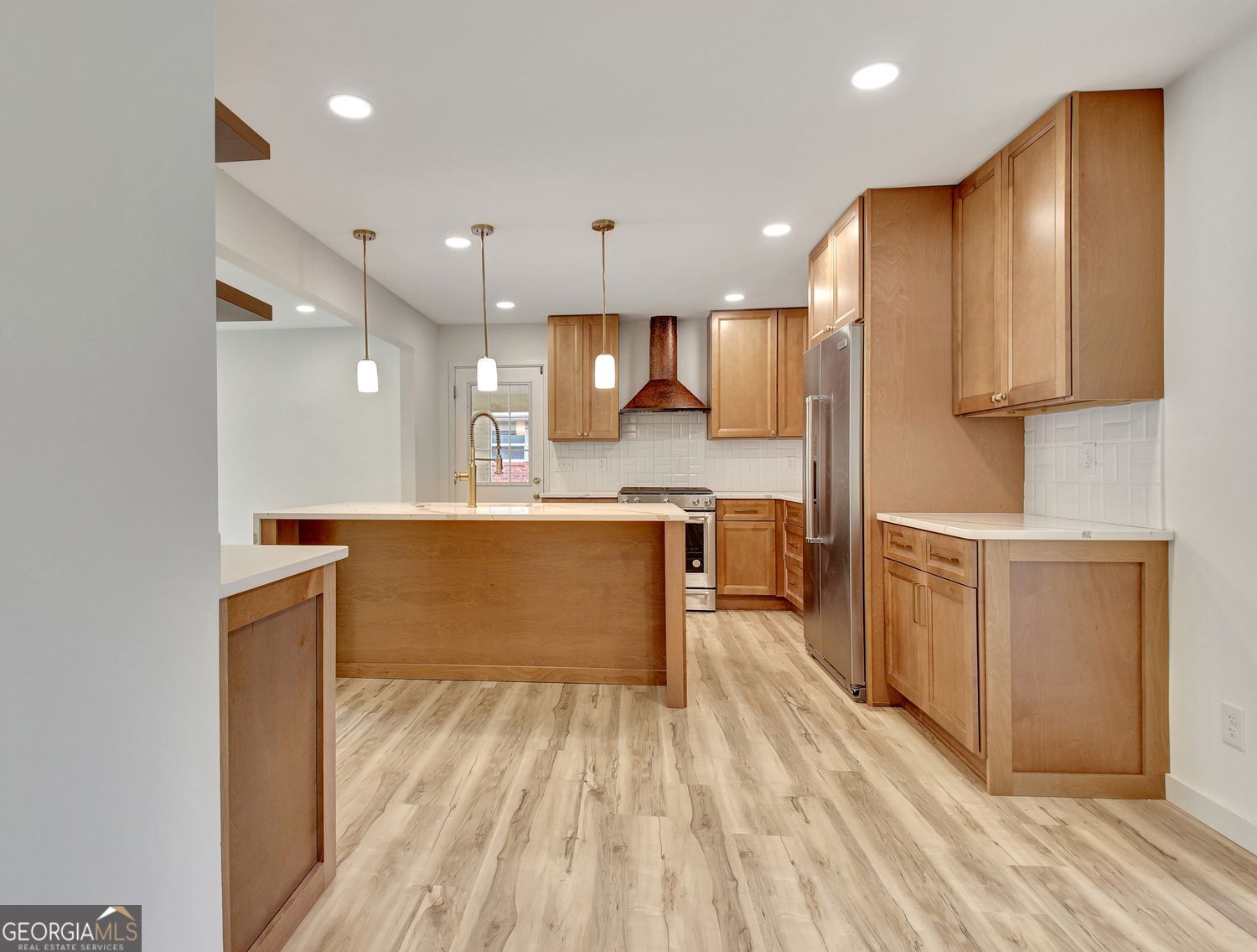 183 Pine Street Northeast Fairburn, GA 30213 - Photo 15 of 68 a large kitchen with a large counter top a sink stainless steel appliances and cabinets