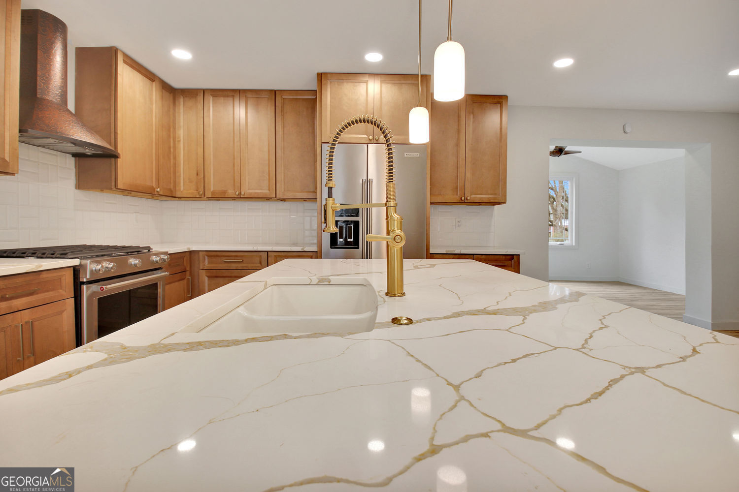 183 Pine Street Northeast Fairburn, GA 30213 - Photo 18 of 68 a kitchen with stainless steel appliances kitchen island granite countertop a sink a stove and a refrigerator