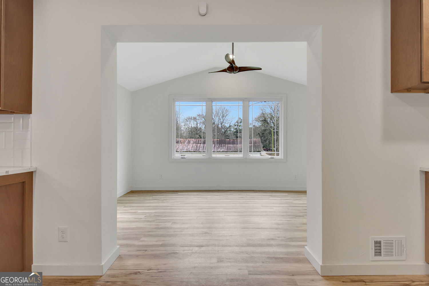 183 Pine Street Northeast Fairburn, GA 30213 - Photo 26 of 68 a view of an empty room with wooden floor and a window