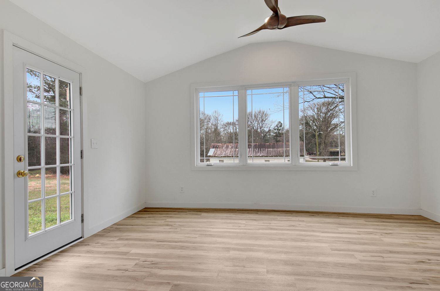 183 Pine Street Northeast Fairburn, GA 30213 - Photo 29 of 68 a view of an empty room with wooden floor and a window