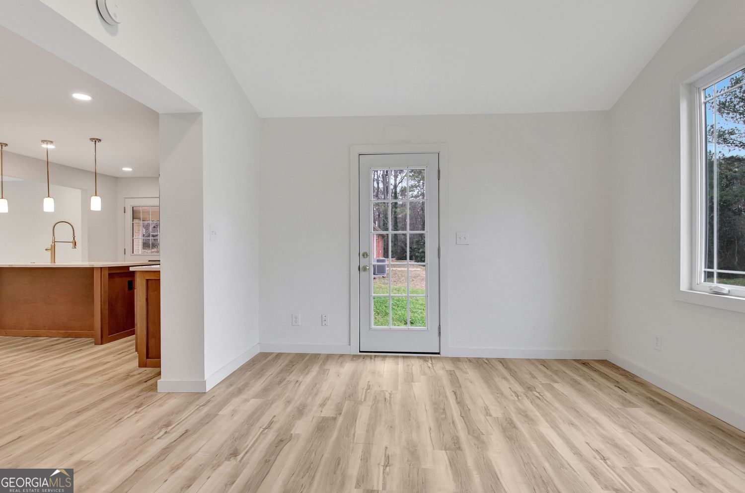 183 Pine Street Northeast Fairburn, GA 30213 - Photo 31 of 68 a view of an empty room with wooden floor and a window