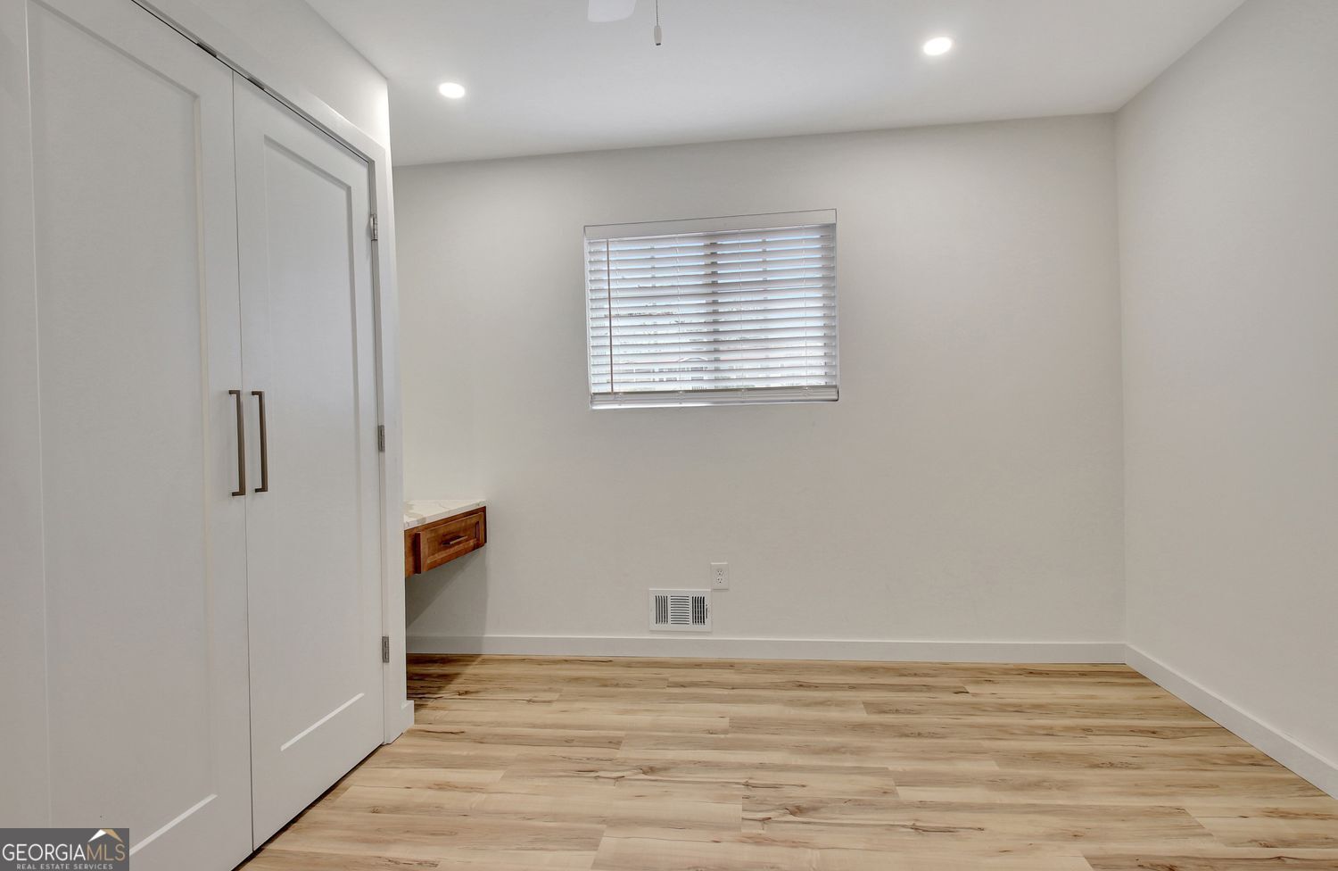 183 Pine Street Northeast Fairburn, GA 30213 - Photo 35 of 68 a view of an empty room with wooden floor and a window