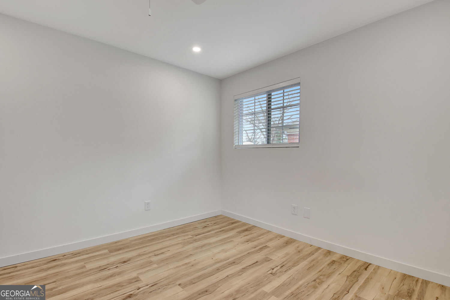 183 Pine Street Northeast Fairburn, GA 30213 - Photo 44 of 68 an empty room with wooden floor and windows