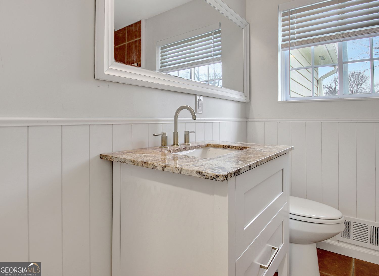 183 Pine Street Northeast Fairburn, GA 30213 - Photo 49 of 68 a bathroom with a granite countertop sink a toilet and a window