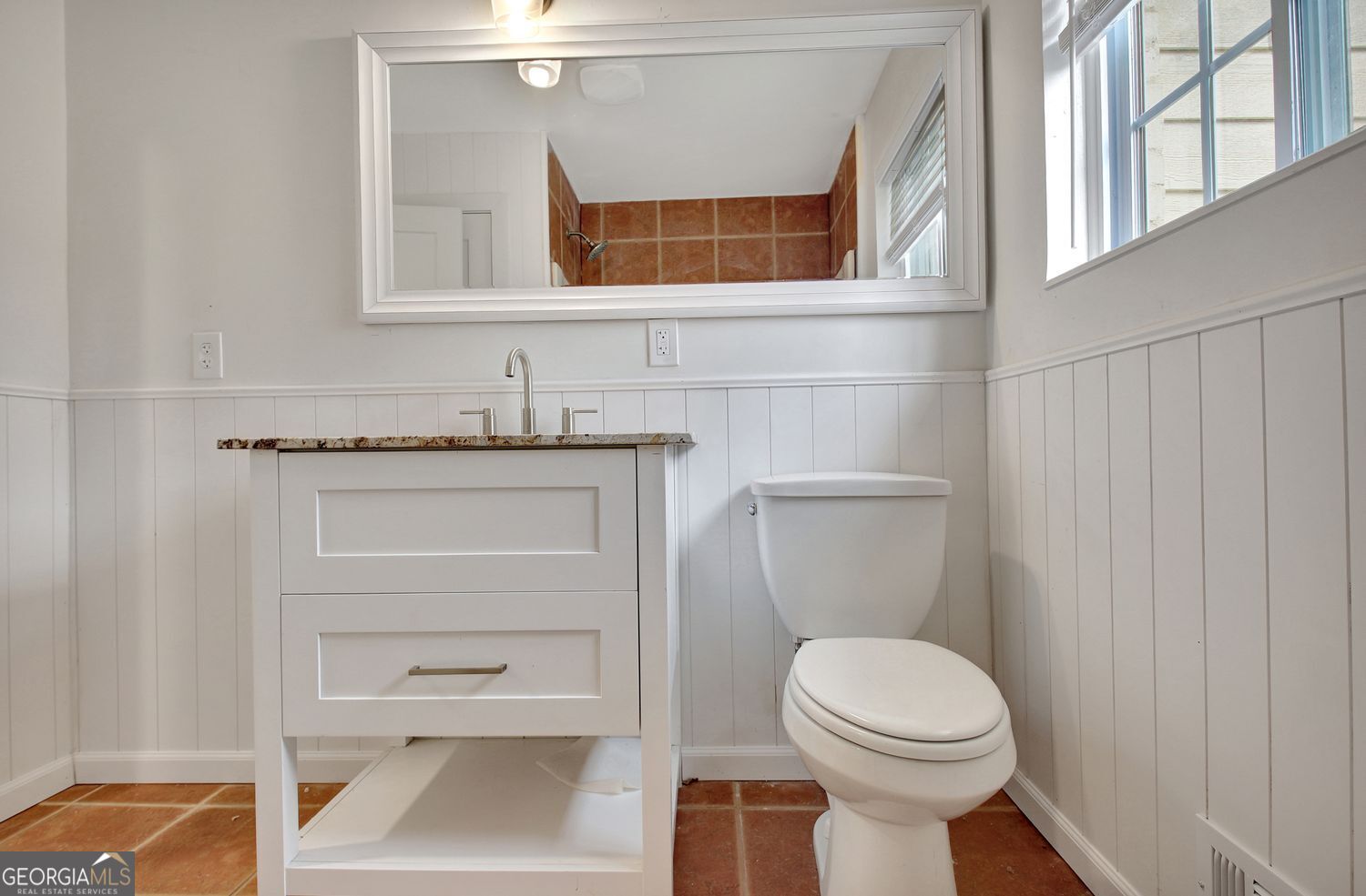 183 Pine Street Northeast Fairburn, GA 30213 - Photo 50 of 68 a bathroom with a toilet a sink and a window