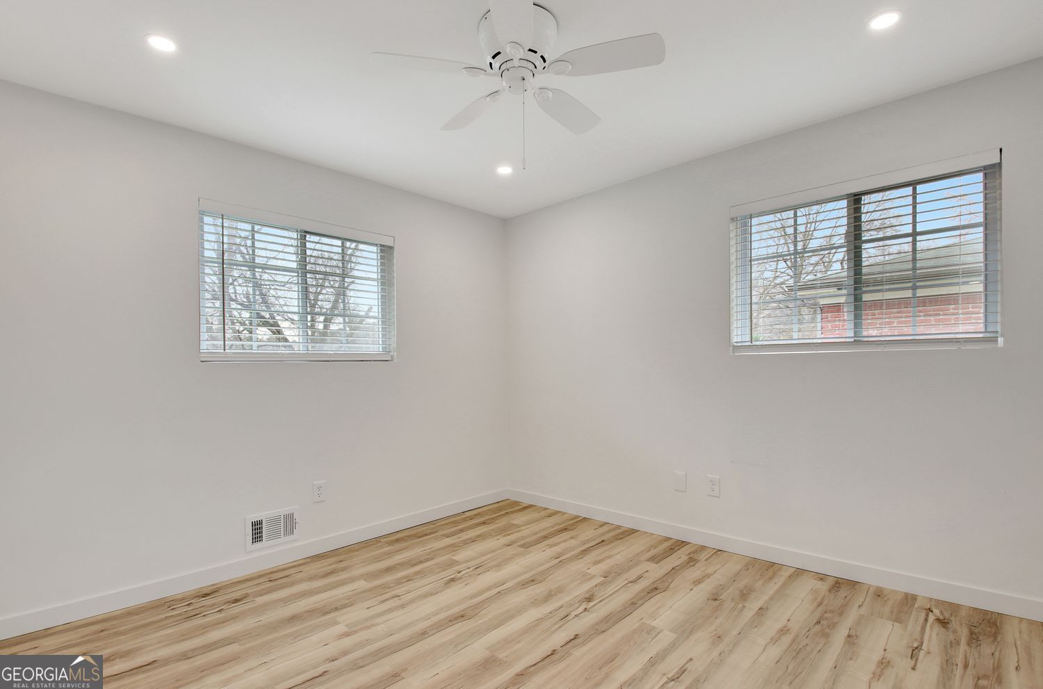 183 Pine Street Northeast Fairburn, GA 30213 - Photo 52 of 68 a view of empty room with wooden floor and fan